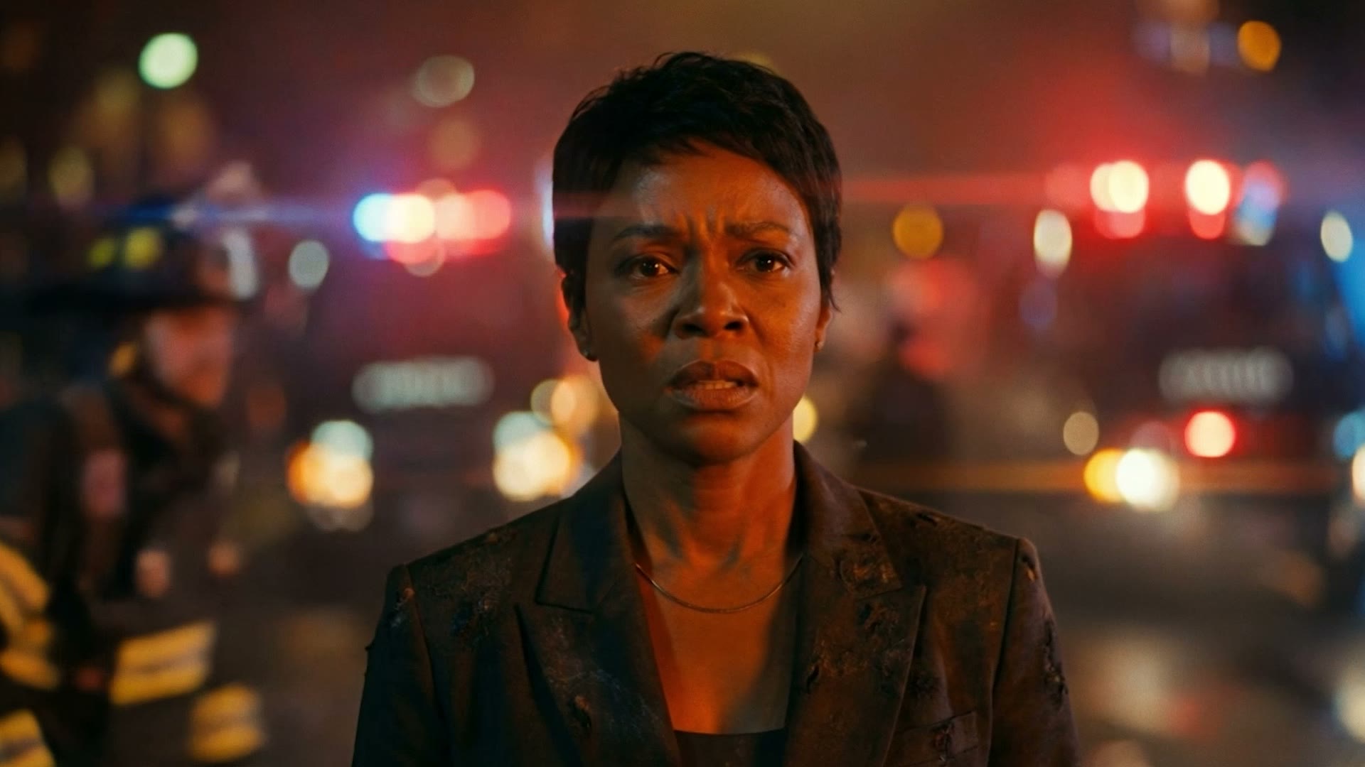 The head of HR, suit smoking, sirens behind her
