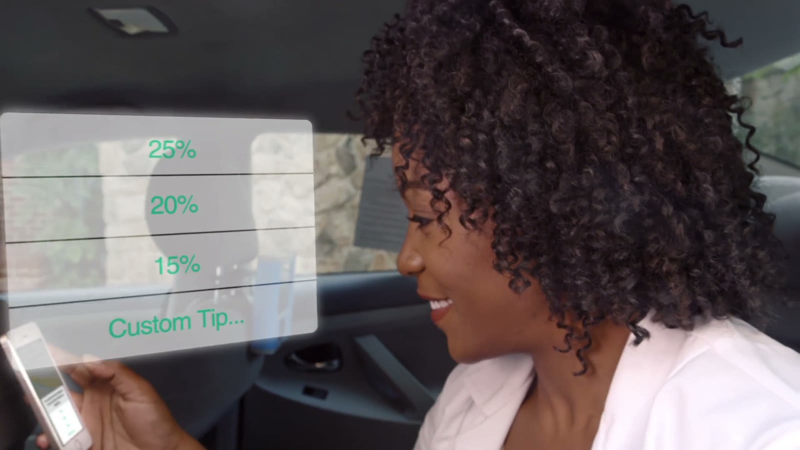 The doctor in the back of a cab, choosing a tip on her phone