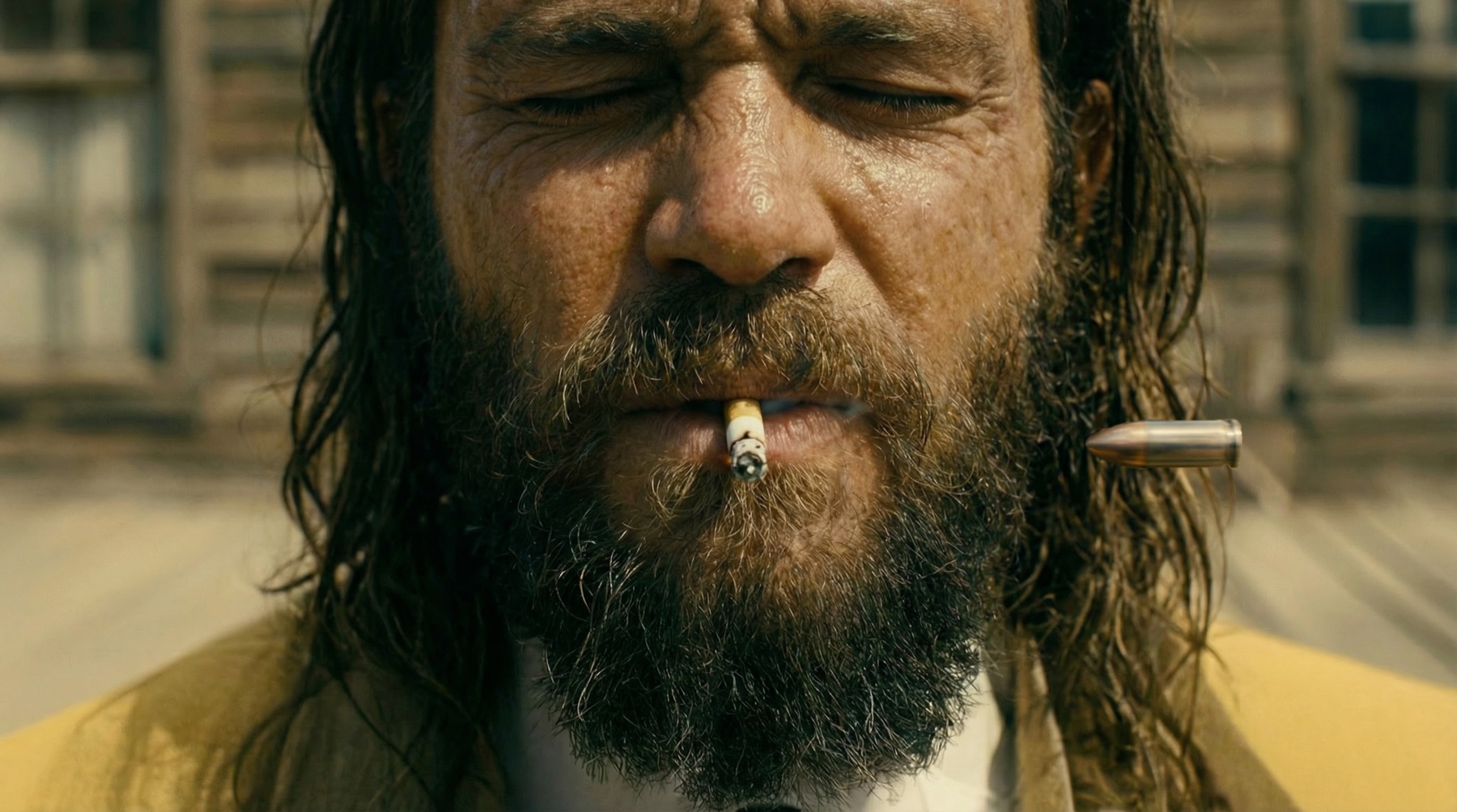 Gold Miner's Daughter: a bearded man, eyes closed, a cigarette in his lips and a bullet flying past